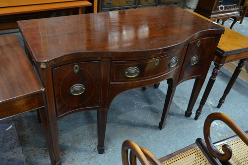 A George III mahogany serpentine form sideboard