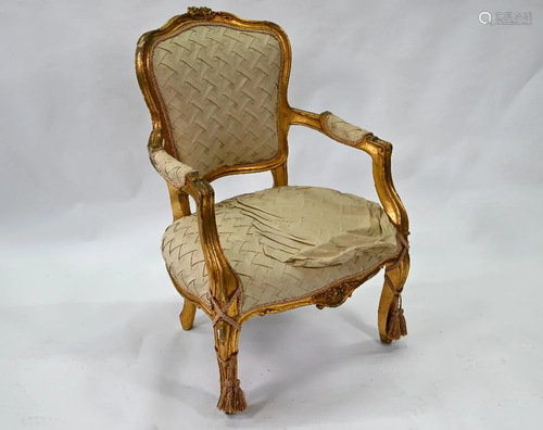 A giltwood and silk salon armchair