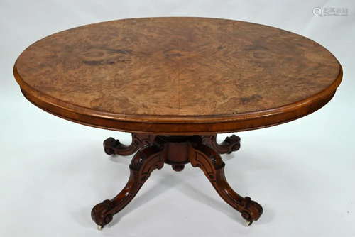 A Victorian walnut oval tilt top breakfast table