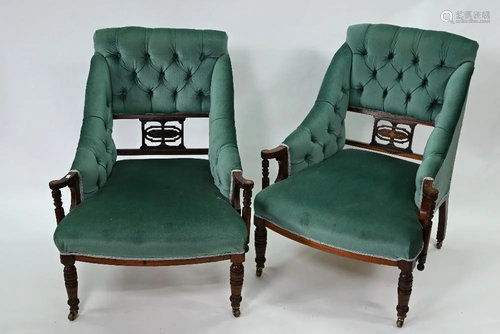 A pair of late Victorian button backed open armchairs