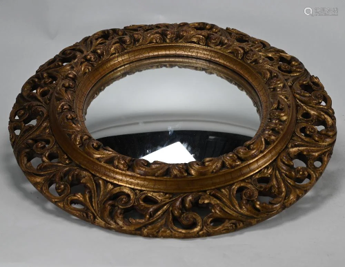 An old circular moulded giltwood mirror