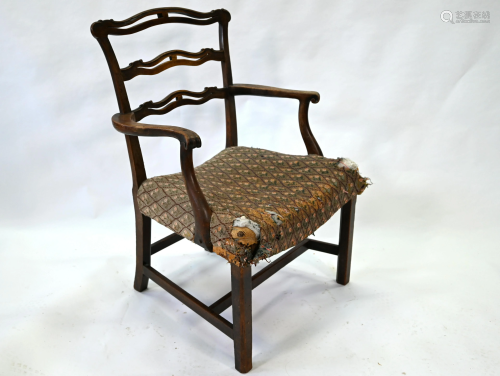 An 18th century oak wavy ladderback elbow chair