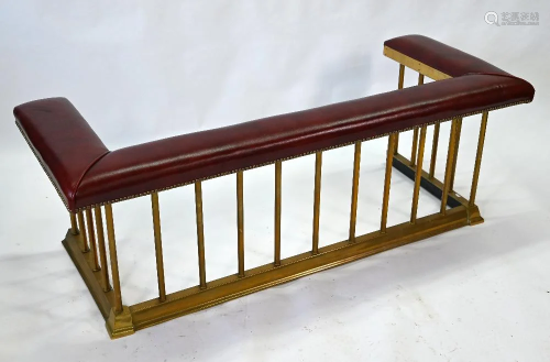 A traditional red leather and brass rail club fender