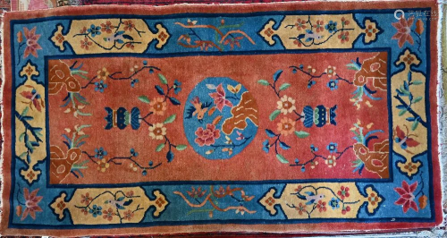 An old Chinese rug, brown/red ground with floral