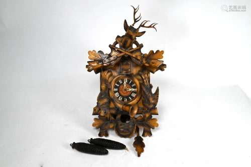 An antique Black Forest pitch pine cuckoo clock