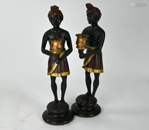 A pair of cold-painted bronze figural candlesticks