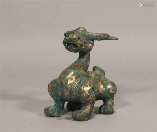 A CHINESE GILDED BRONZE MYTHICAL BEAST