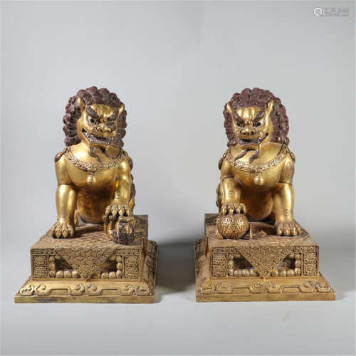 A PAIR OF GILDED BRONZE LIONS