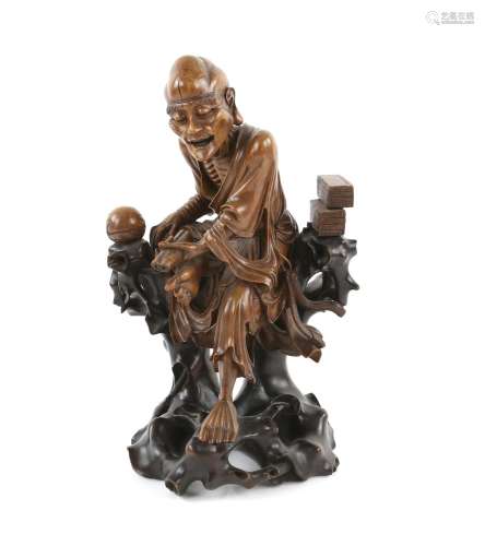 Chinese carved hardwood figure of a seated old man holding a...