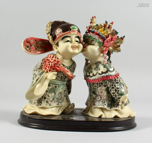 A JAPANESE STYLE POTTERY GROUP of two young children