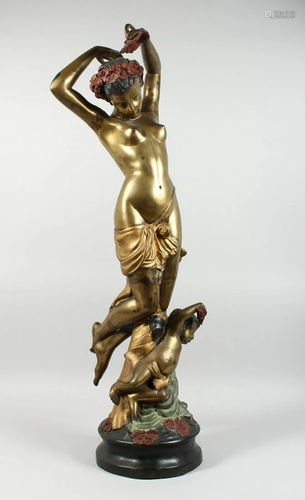 A TWO COLOUR GILDED BRONZE OF A STANDING NUDE wit…