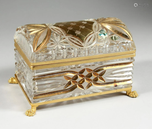 A CUT GLASS AND GILDED CASKET with domed top on clawed