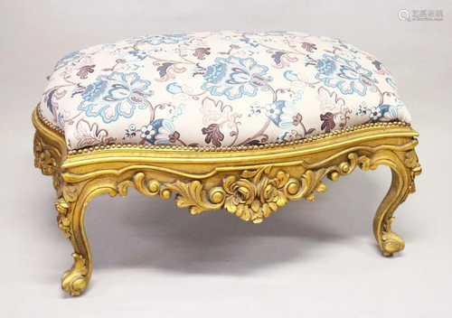 A GILT WOOD LARGE STOOL, upholstered with a floral