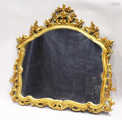 A GILT OVERMANTLE MIRROR with domed glass and pierced