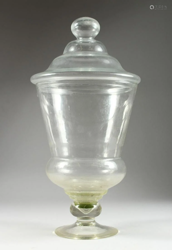 A LARGE PLAIN GLASS SWEETIE JAR AND COVER, 26 ins high.