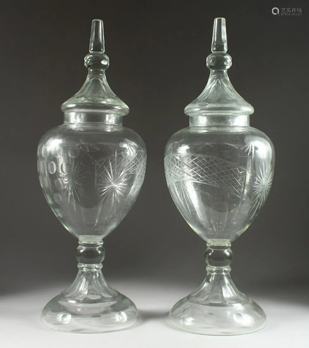 A LARGE PAIR OF CUT GLASS URN, SHAPED VASES AND COVERS,