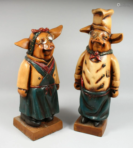 A PAIR OF AMUSING POTTERY PIGS, 24 in. and 21 in. high.
