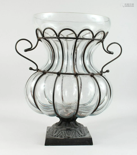 A LARGE SHAPED MOULDED GLASS BULBOUS VASE in a metal