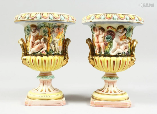 A PAIR OF CAPODIMONTE STYLE POTTERY URNS AND COVERS