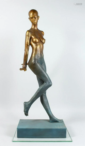 AN ABSRACT STANADING BRONZE NUDE on a rectangular base.