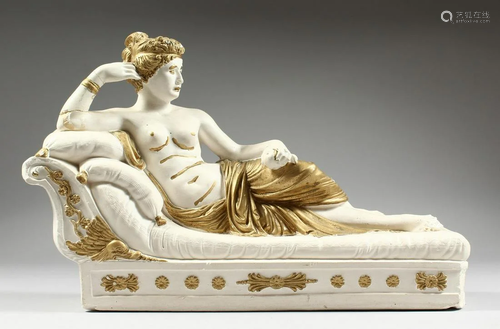 A POTTERY SEMI NUDE on a chaise longue, 15 ins. long