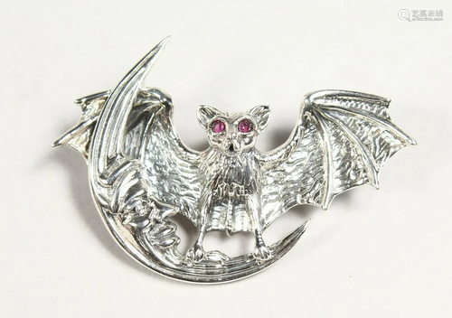 A SILVER RUBY EYE BAT AND MOON BROOCH PENDANT