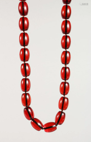 A STRING OF FAUX-AMBER BEADS