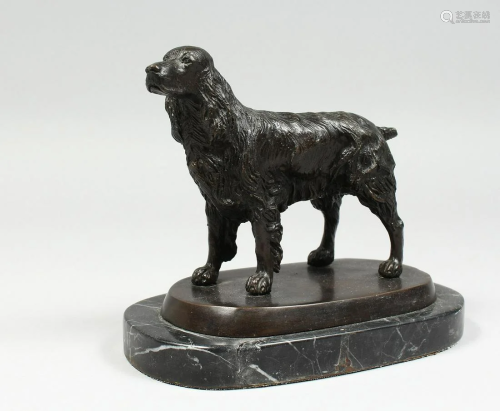 A BRONZE SPANIEL on a marble base, 6 ins long.