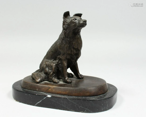 A BRONZE DOG on a marble base. 5 ins high.