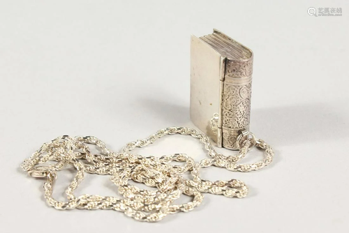 A SILVER BOOK PENDANT ON A CHAIN