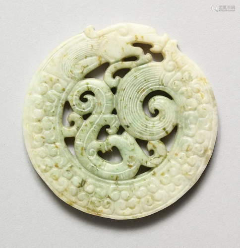 A CHINESE PIERCED JADE ROUNDEL, 2.75 ins diameter.