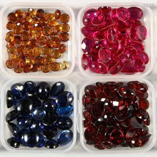 FOUR SMALL BOXES OF CABOCHON STONES