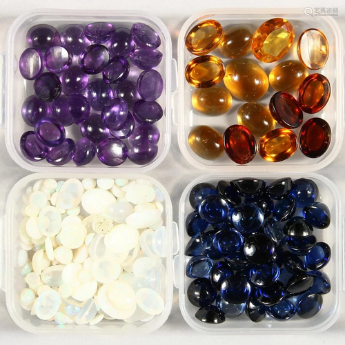 FOUR SMALL BOXES OF CABOCHON STONES