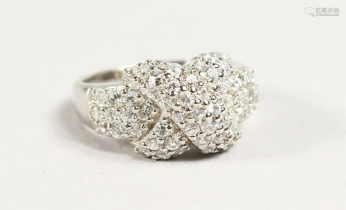 A SILVER AND CZ CROSSOVER RING