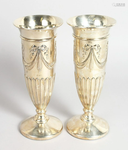 A PAIR OF SILVER FLUTED FLOWER VASES on circular bases