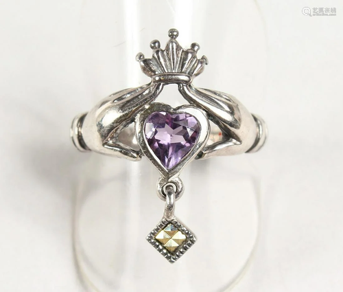 A SILVER AND CLADDAGH RING