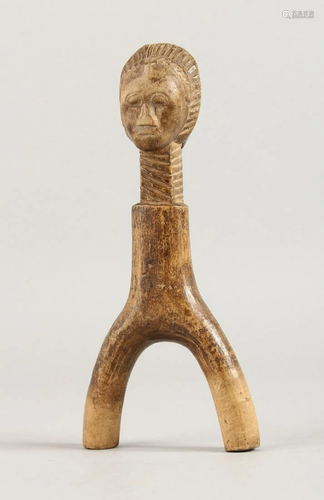 AN AFRICAN CARVED WOOD FIGURE. 8ins long.