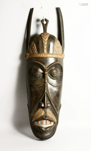 A LARGE CARVED WOOD ETHNIC MASK. 3ft long.