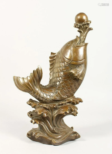 A CHINESE BRONZE CARP on a scrolling base. 7 ins high.