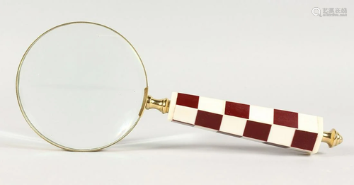 A CHECKERED HANDLED MAGNIFYING GLASS