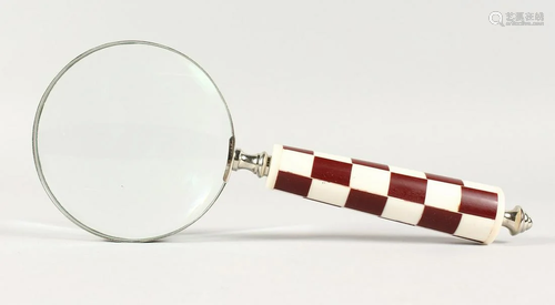 A CHECKERED HANDLED MAGNIFYING GLASS