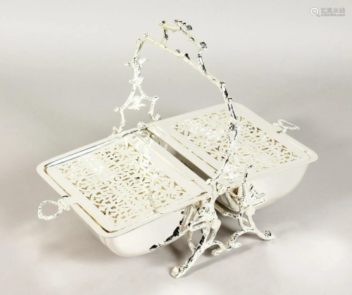 A SILVER PLATED BISCUIT AND CHEESE STAND on a rustic