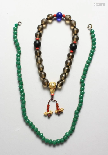 ASIAN PRAYER BEADS WITH GILT CHARM and a jade necklace,