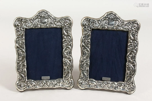 A PAIR OF REPOUSSE DECORATED PHOTOGRAPH FRAMES …