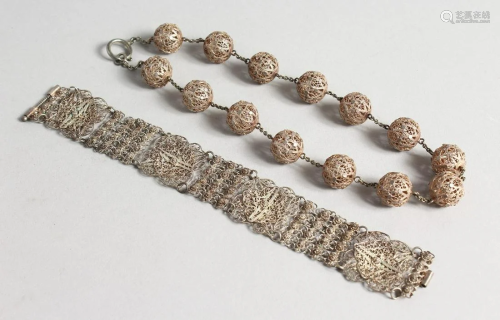 AN ISLAMIC SILVER FILIGREE BRACELET AND NECKLACE.