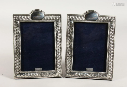 A PAIR OF SCROLL DECORATED PHOTOGRAPH FRAMES, 7 ins x