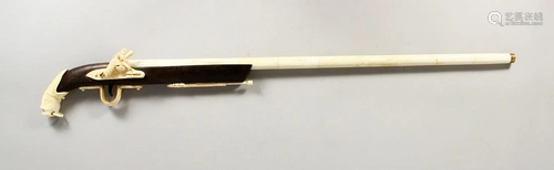 A CARVED BONE FLINTLOCK GUN WALKING STICK