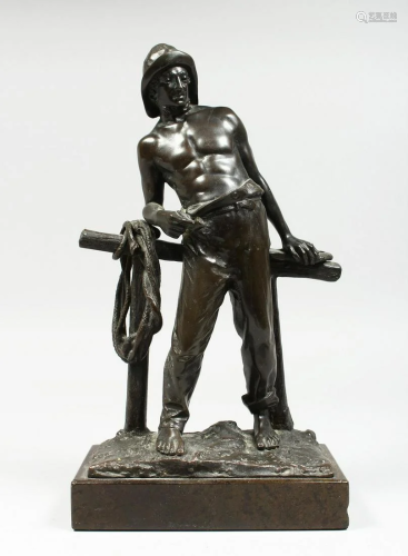 P. KOMDLEZEUSKI A BRONZE OF A FISHERMAN standing in