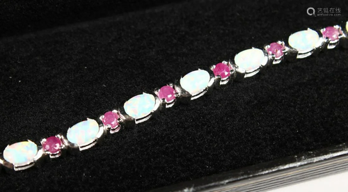 AN OPAL AND RUBY SILVER TENNIS BRACELET.