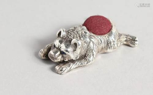 A SILVER LYING BEAR PIN CUSHION